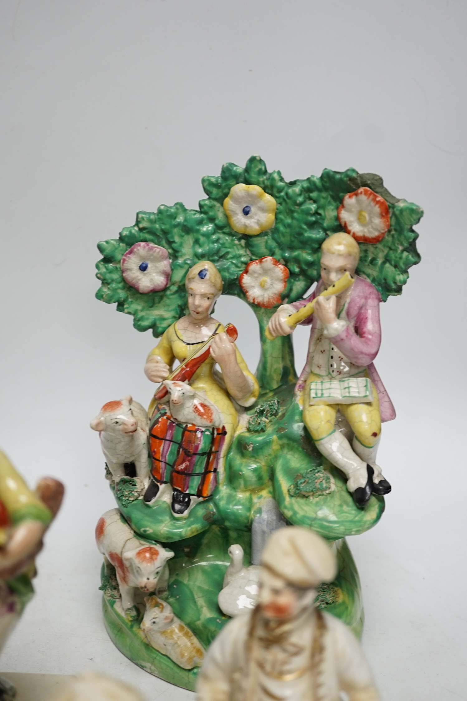 A Staffordshire pottery group of two figures with chickens, c.1800-10, a pair of early 20th century Staffordshire pottery figure groups and three small character figures, tallest 25cm high (6)